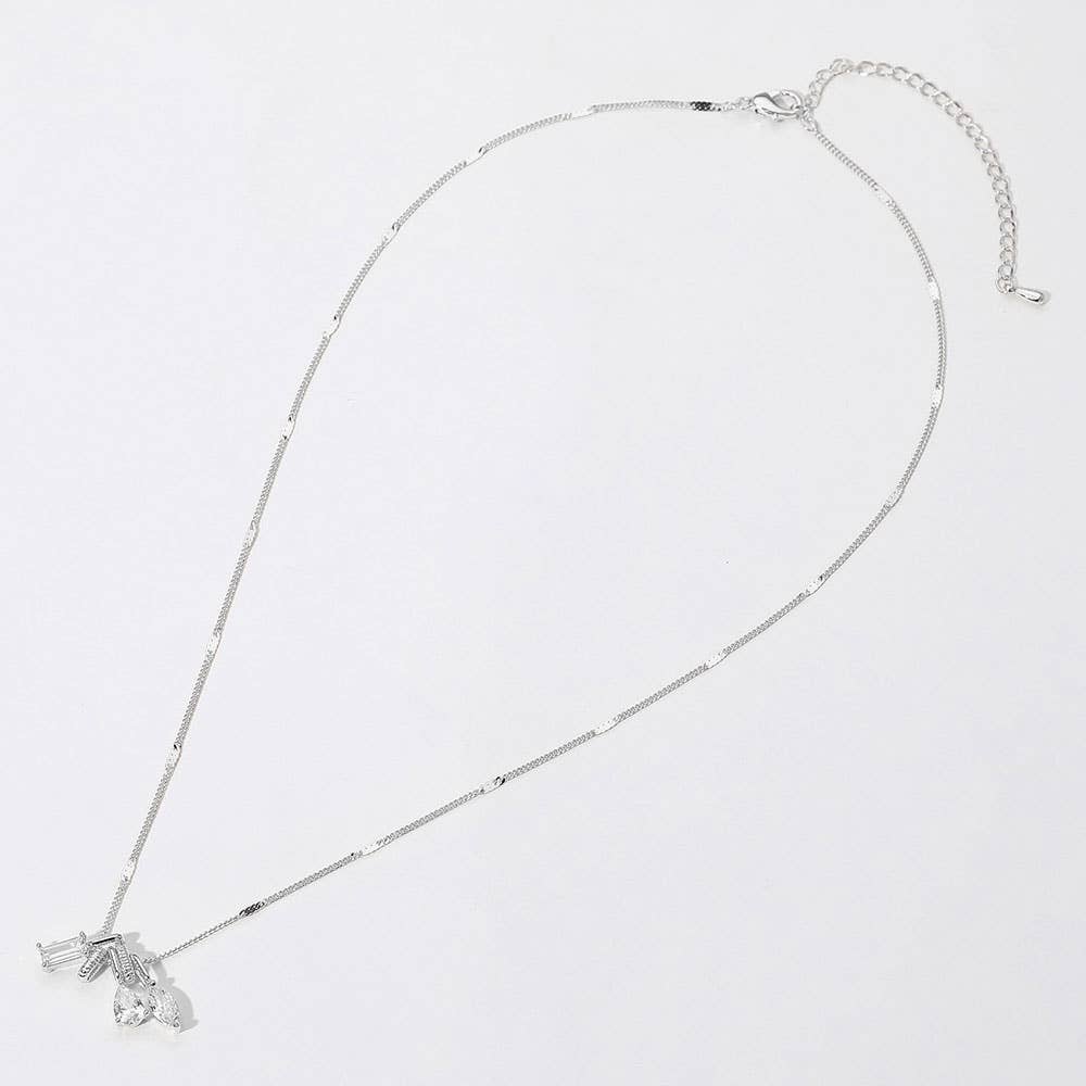 Silver necklace with a small pendant on a light gray background