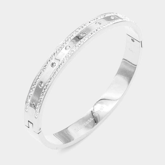 Silver ring with small diamonds on a light gray background